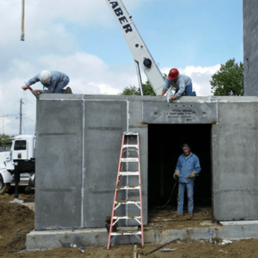 Men building a concrete vault